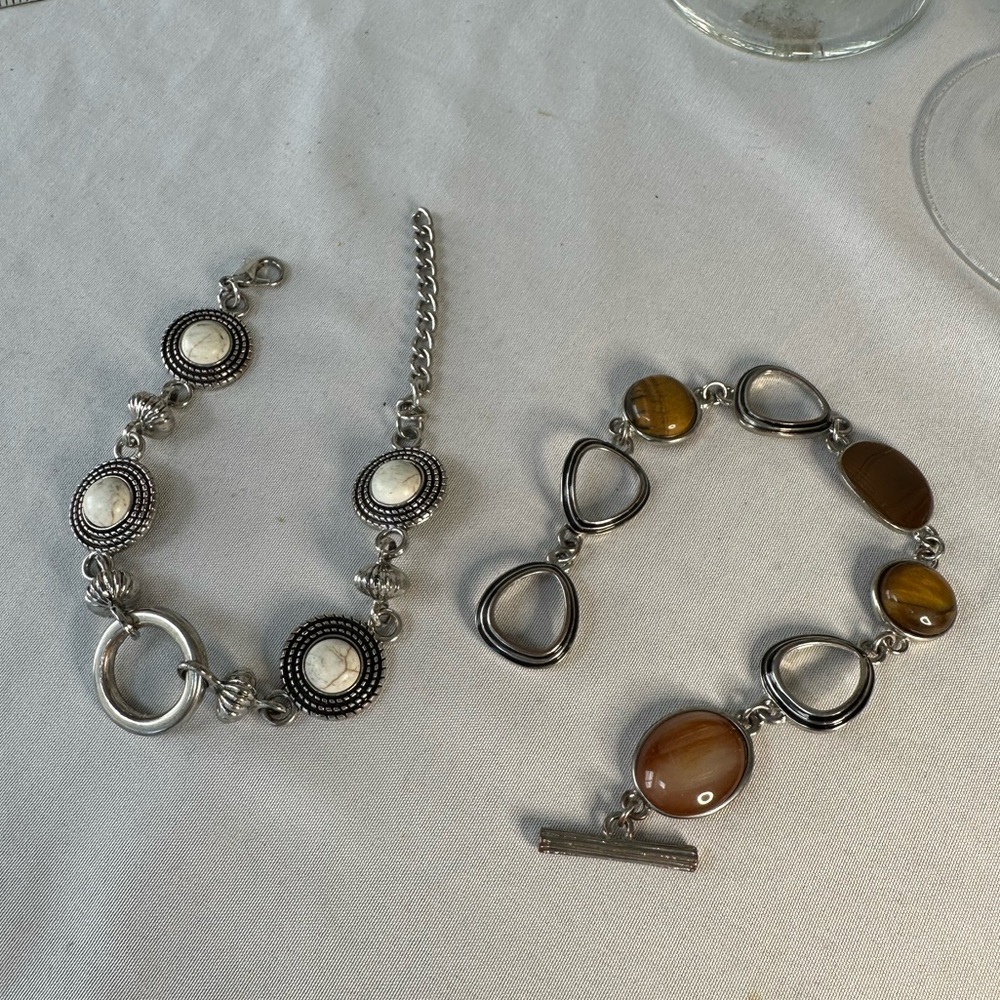Two link style silvertone bracelets